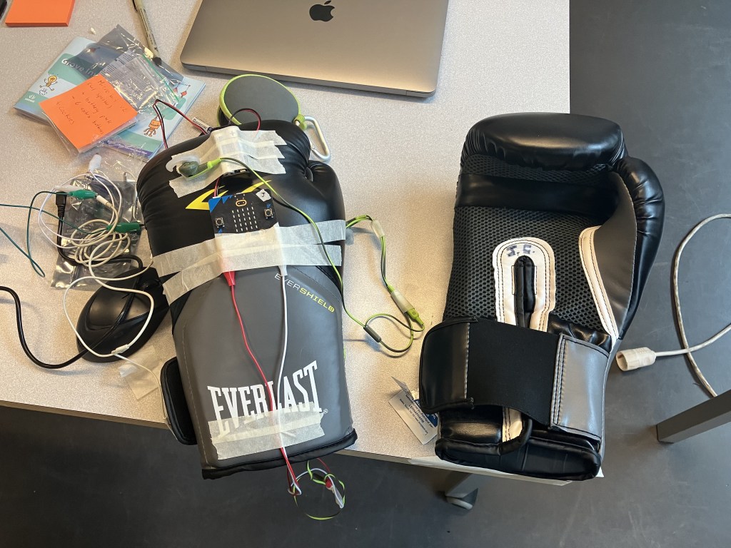 Boxing gloves with electronic components taped on.